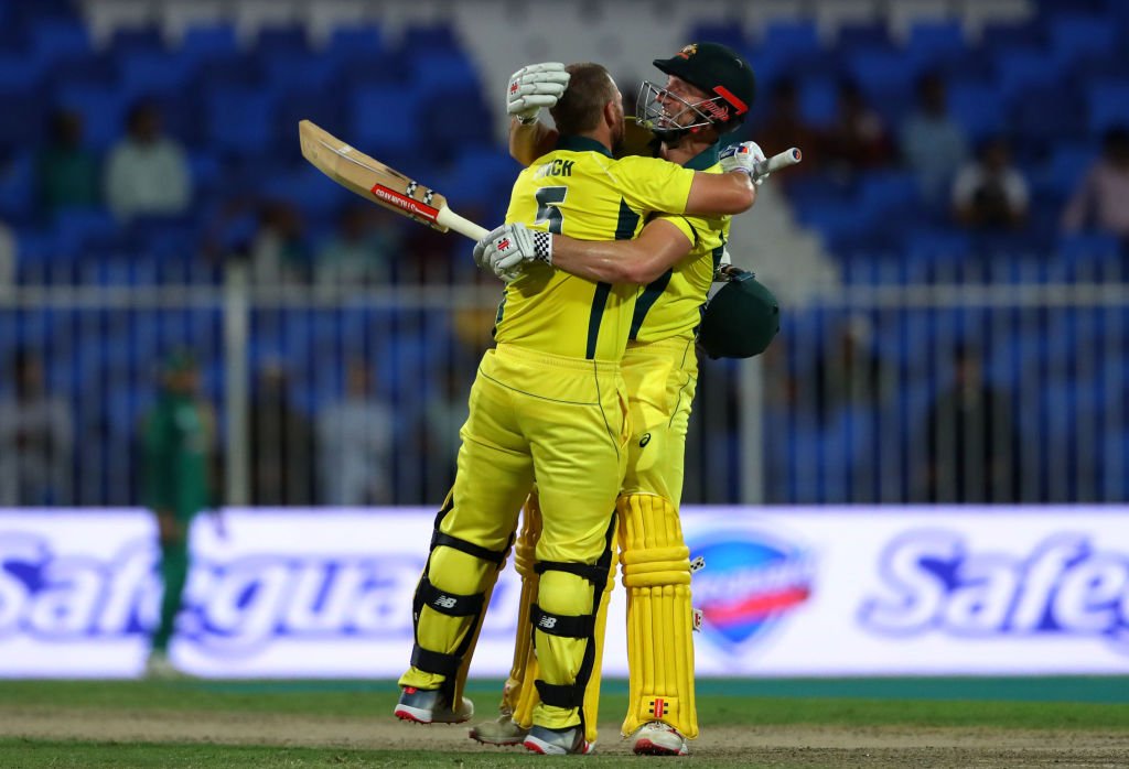 Aaron Finch celebrates his ton with Shaun Marsh