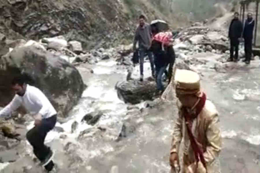 groom crossing river to reach to bride to marry in chamoli