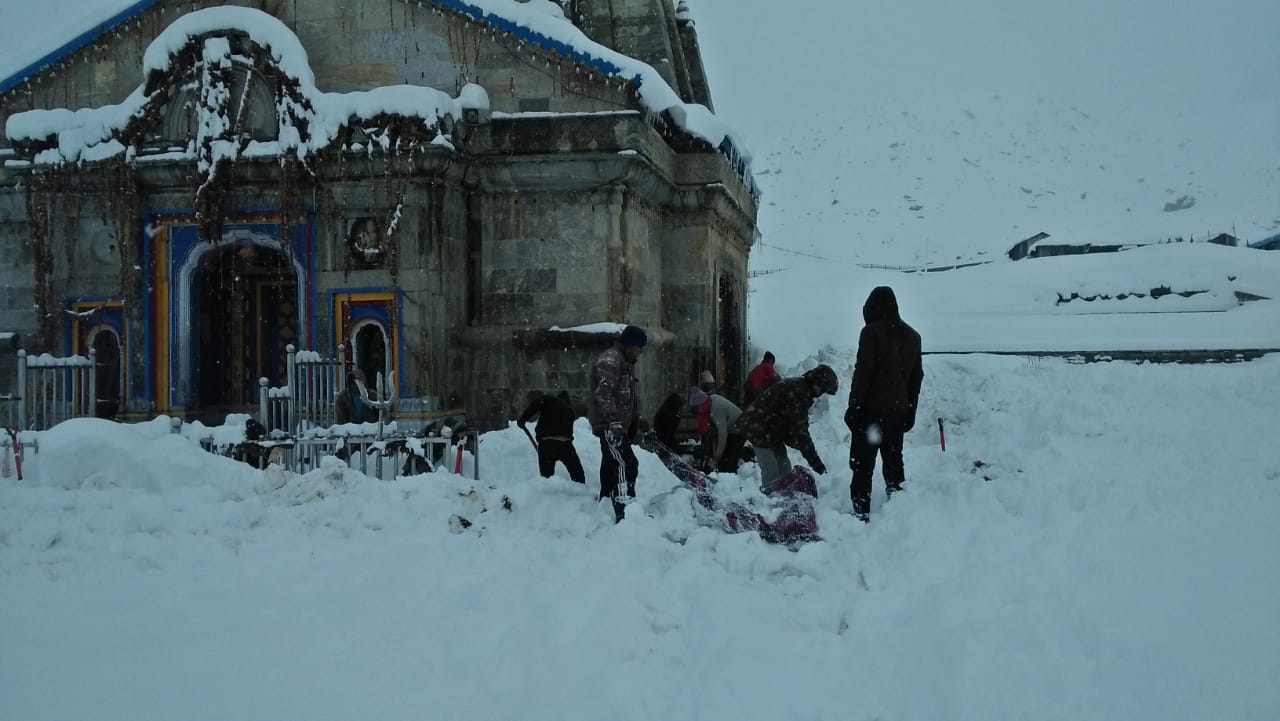 administration and temple committee removing snow from Kedarnath temple