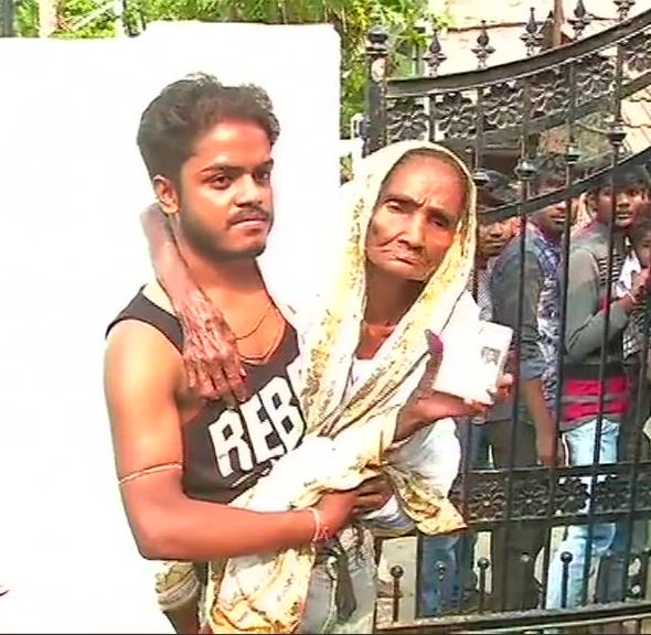 Man carries his 87-year mother to a polling booth