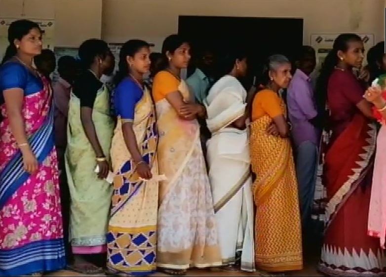 People queue up at a polling booth in wayanad