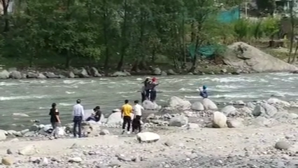 tourists avoiding warning board near beas river