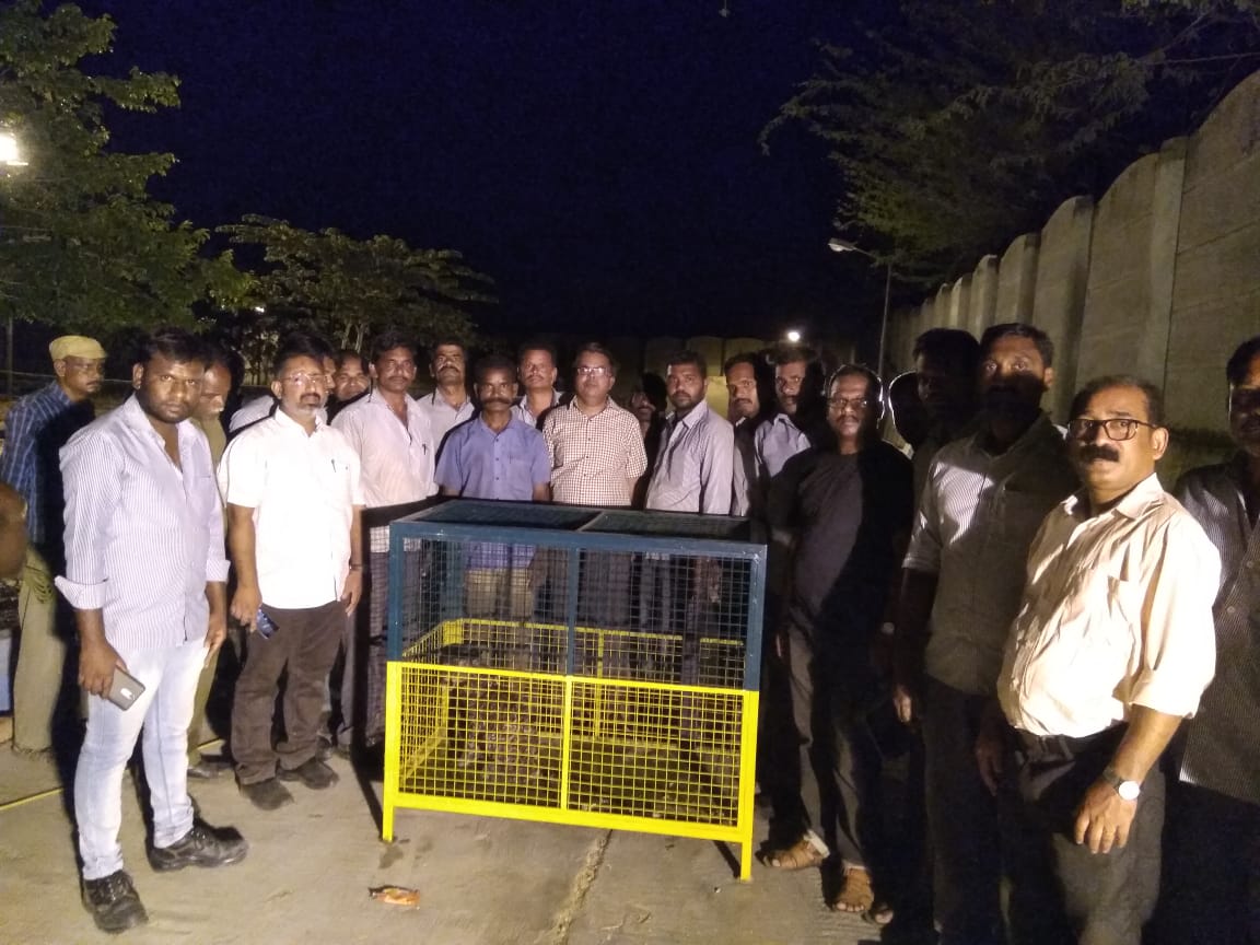 Forest officials with the cage