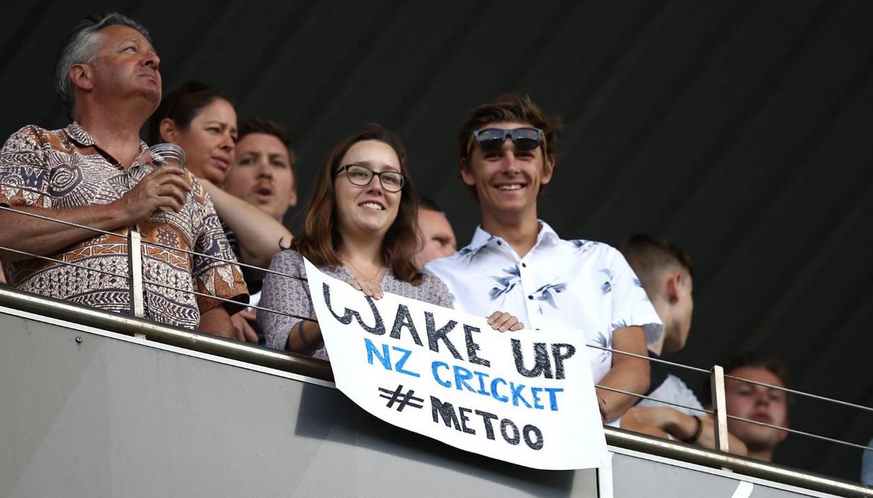 Fans carrying posters reading 