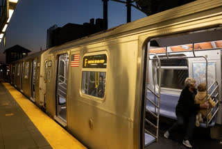 Commuters sit on the F train at the Coney Island-Stillwell Avenue Station, Thursday, Dec. 26, 2024, in New York.