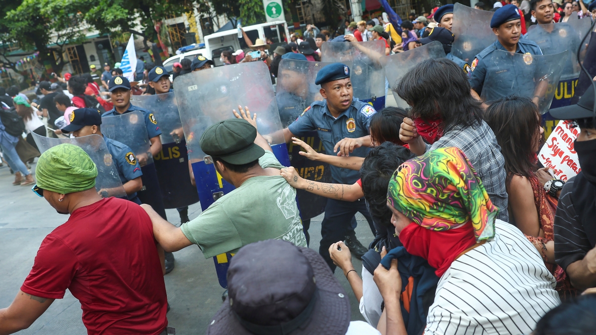 Policemen try to block activists as they tried to march towards the U.S. Embassy during a protest to mark International Labor Day in Manila, Philippines on Wednesday, May 1, 2024. Hundreds of Filipino workers from various labor groups took to the streets to mark Labor Day and demand a wage increase and job security amid soaring food and oil prices. (AP Photo/Basilio Sepe)