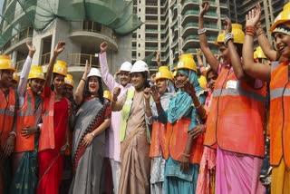 Delhi CM Rekha Gupta (M) interacts with workers on International Labour Day, 2025