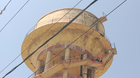 Mother and daughter climb on water tank