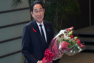 Japan's outgoing Prime Minister Fumio Kishida stops as media members asked him to make a comment before he leaves the prime minister's office in Tokyo Tuesday, Oct. 1, 2024.