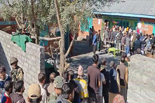 People queue up outside polling booths in Kashmir