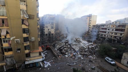 Smoke seeps out from building rubble at the site of an overnight Israeli airstrike on the Laylaki neighbourhood in Beirut's southern suburbs on October 1, 2024.