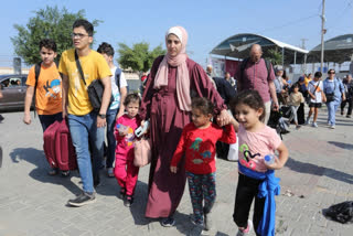 Dozens of foreign passport holders could be seen entering the Rafah crossing from Gaza to Egypt on Wednesday.