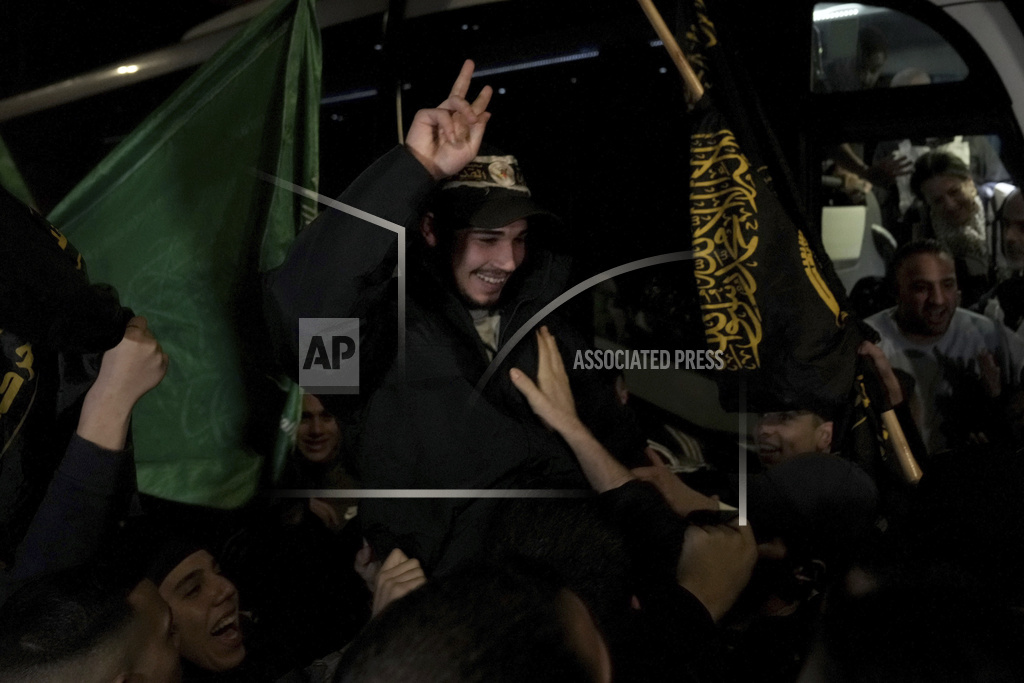 Palestinian Abdulkareem Abu Mustafa waves after being released from prison by Israel
