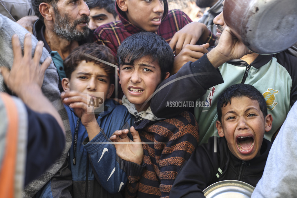 Palestinians line up for food in Rafah, Gaza Strip