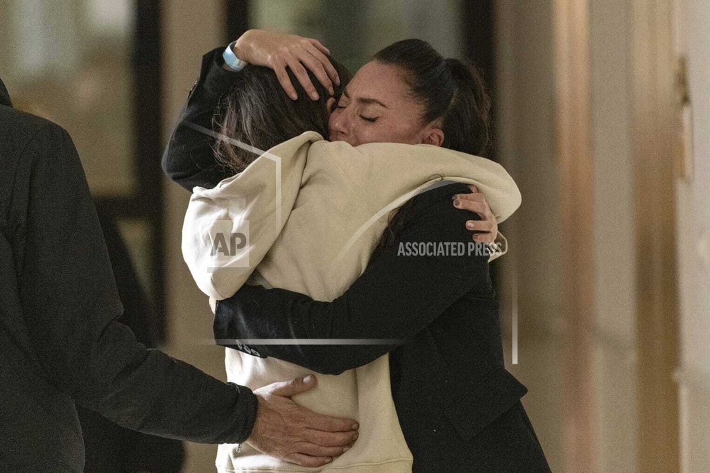 Israeli released hostage Moran Stela Yanai, left, meeting with members of her family at Sheba Medical Center in Ramat Gan, Israel