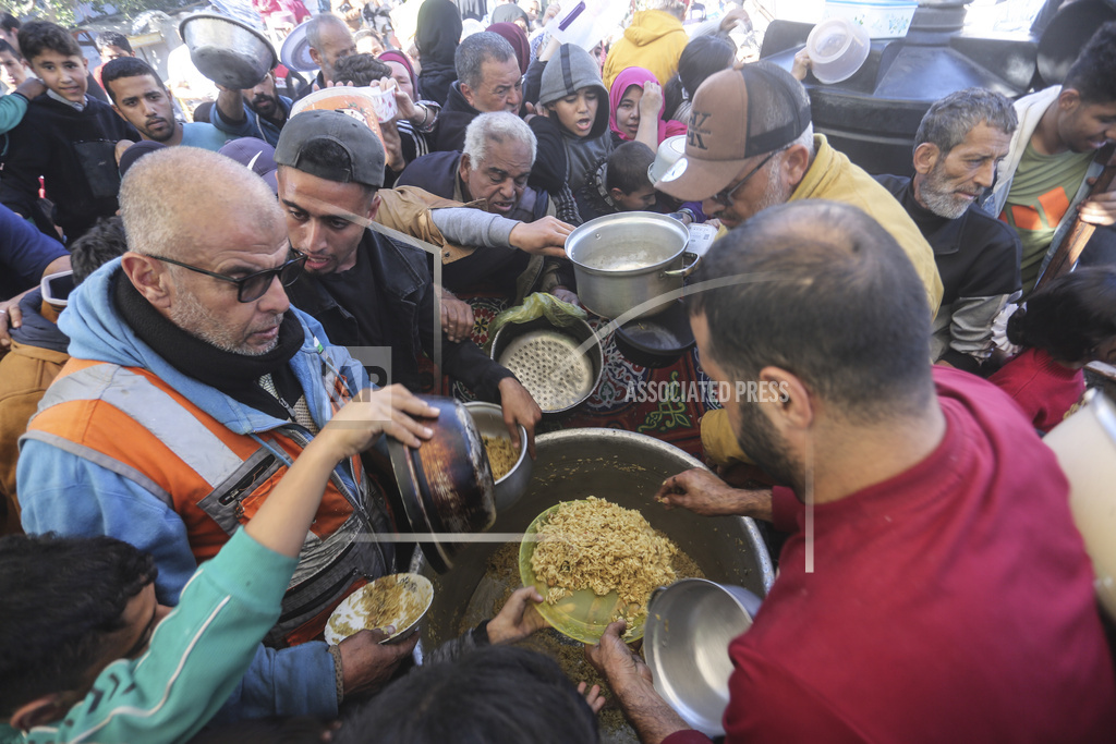 Palestinians line up for food in Rafah, Gaza Strip