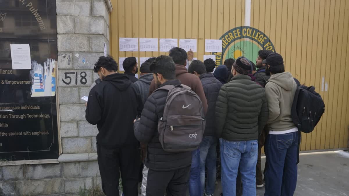 Candidates for police constable posts check their roll numbers outside an exam centre in Pulwama on Sunday, Dec 1, 2024. An estimated 5.6 lakh candidates applied for over 4000 posts