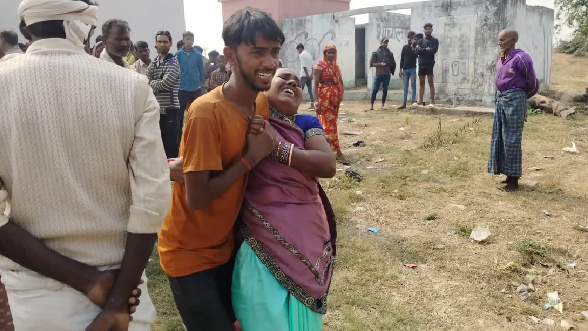 Family members of a deceased girl grieve at the site