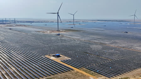 Vast lines of solar panels reflect the blazing sun in India's western deserts, a dazzling ocean broken only by bristling wind turbines. India, along its desolate border with Pakistan, is building what it boasts will be the world's largest renewable power plant, an emblem of a determined push to boost solar energy.