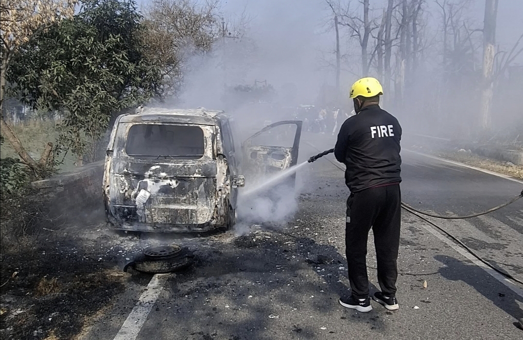 Firefighters extinguishing a fire in a car