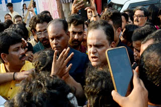 West Bengal Education Minister Bratya Basu, centre, speaks with Students' Federation of India (SFI) members at Jadavpur University campus, in Kolkata, Saturday, March 1, 2025.