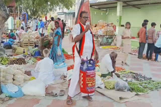 A DMK ACTIVIST CAMPAIGN IN POLLACHI WITH A GAS CYLINDER TIED AROUND HIS WAIST