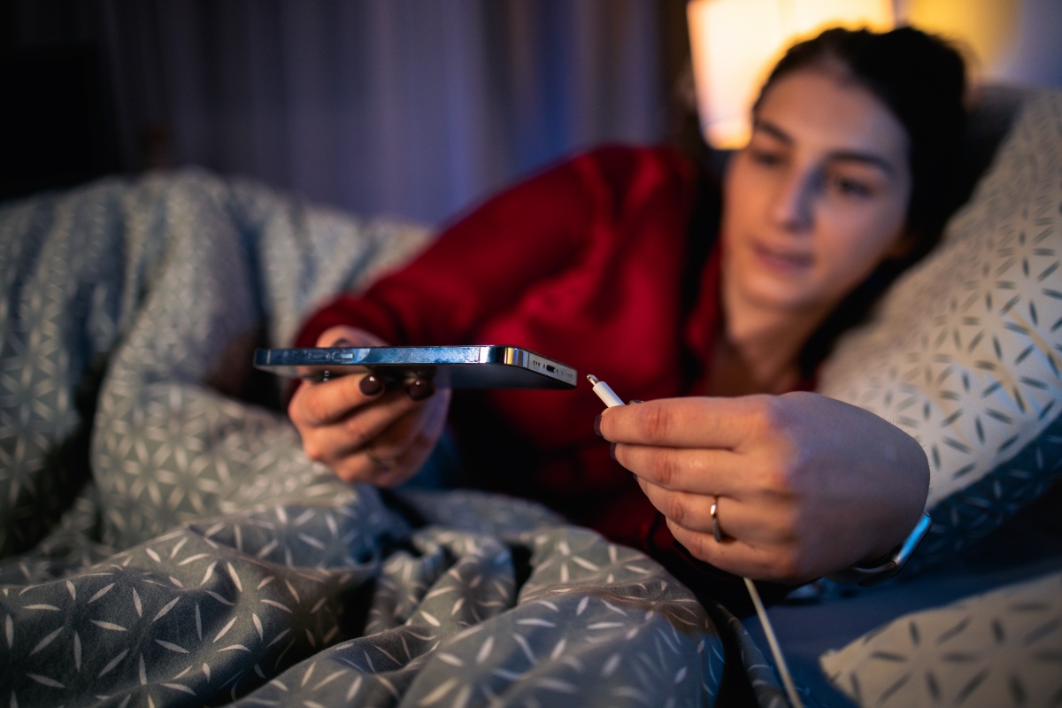 Woman charging her phone before bed