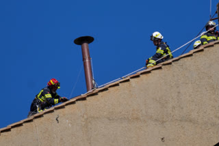 Watch: Vatican Firefighters Install A Chimney On The Roof Of The Sistine Chapel For The Papal Election
