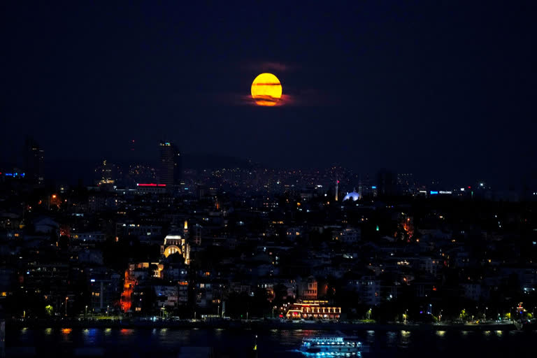 The supermoon rises in the sky as ferries and cargo ships cross the Bosphorus in Istanbul, Turkey, Tuesday, Aug. 1, 2023. (AP)