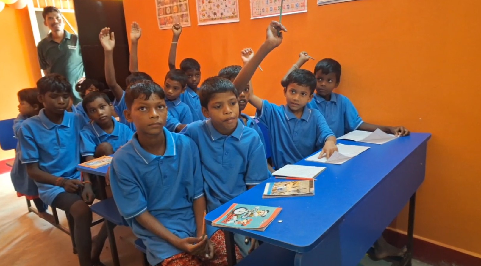 Students in a make-shift smart class at Polpol model village.