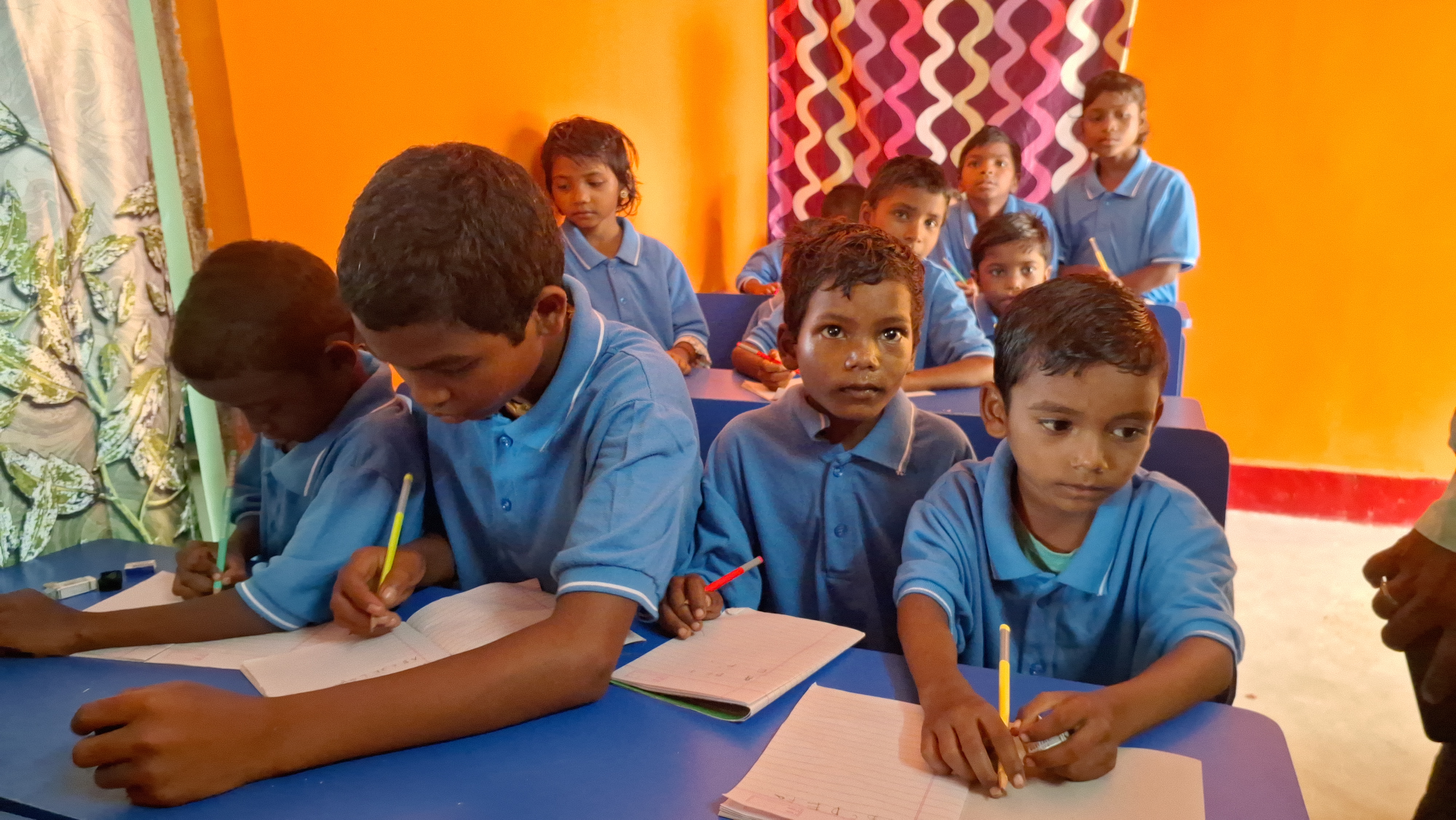 Students in a make-shift smart class at Polpol model village.
