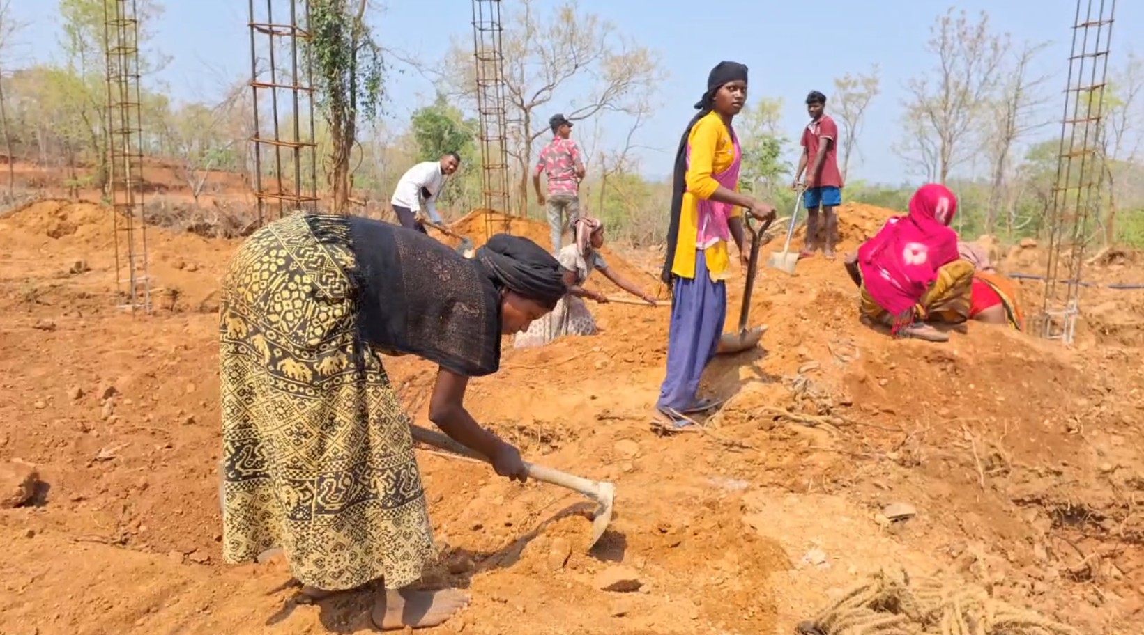 Villagers engaged in construction of houses.