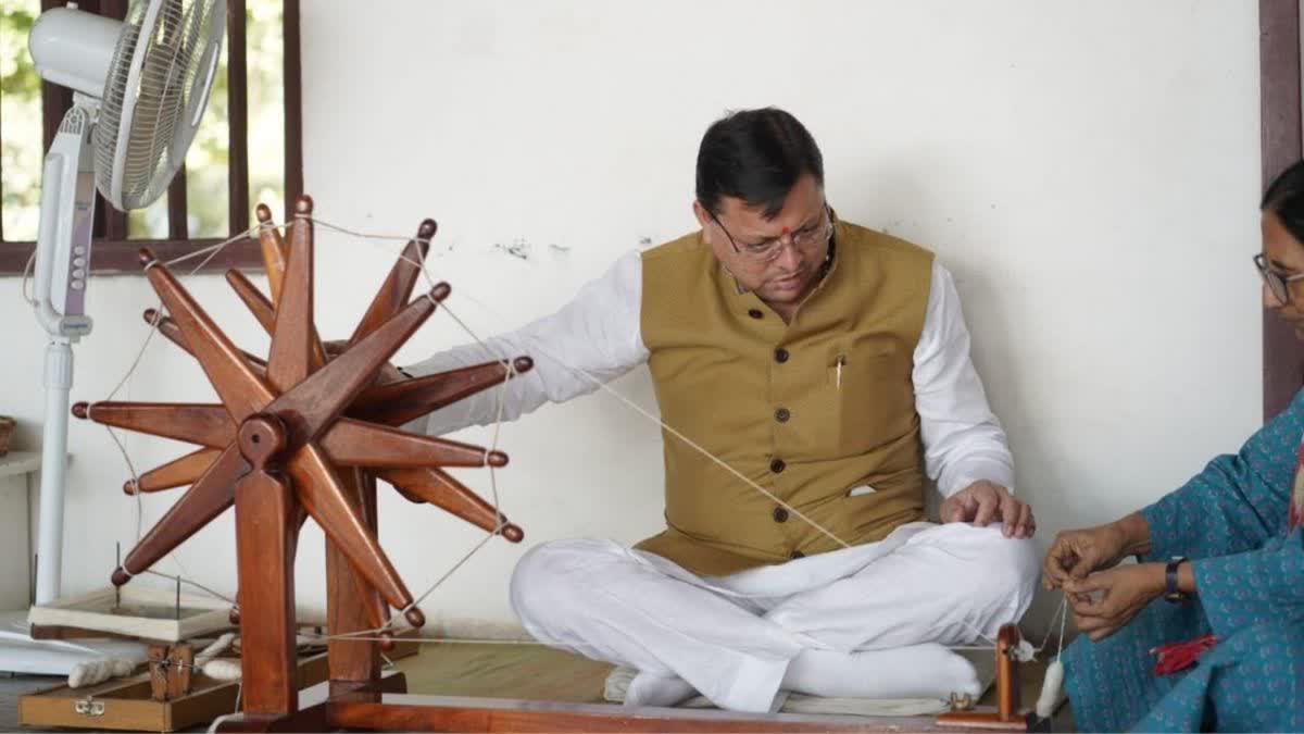 UTTARAKHAND CM DHAMI REMEMBERED MAHATMA GANDHI BY SPINNING CHARKHA AT GANDHI ASHRAM IN AHMEDABAD