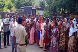 woman protest in front of forest office