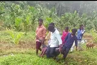 Villagers carry the patient in a sack to the hospital