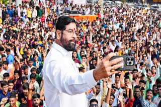 Maharashtra Chief Minister Eknath Shinde takes a selfie with people during Diwali celebrations, at Masunda Lake in Thane on Thursday.