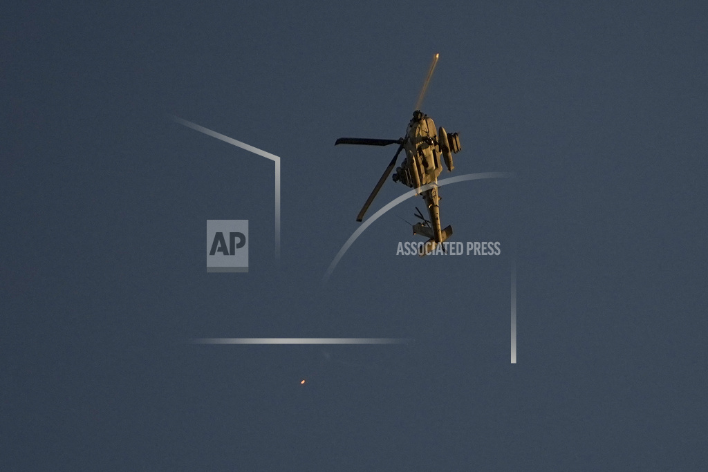 An Israeli Apache helicopter fires flares over the Gaza Strip on Friday