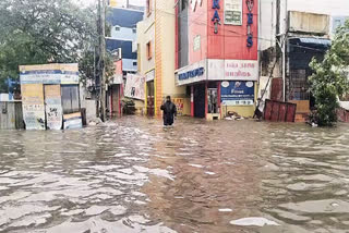 A man walks on a waterlogged road following a heavy rainfall triggered by Cyclone Fengal, in Chennai on Saturday.