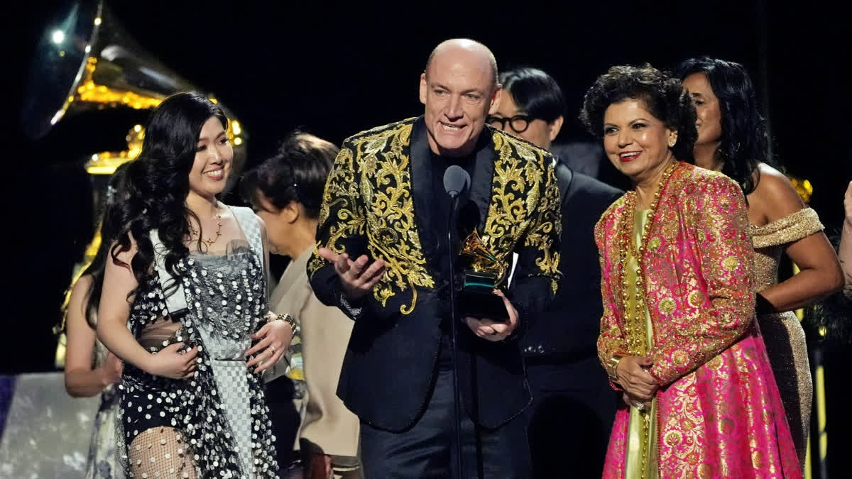 Eru Matsumoto, from left, Wouter Kellerman, and Chandrika Tandon accept the Grammy award