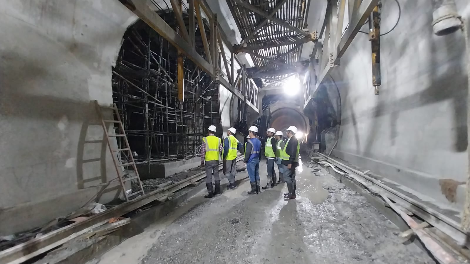 Engineers inspect the work inside a tunnel.