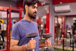 Man holding dumbbells in the gym