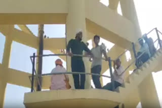 PEOPLE PROTESTED , CLIMBING ON THE WATER TANK