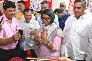 District Collector inaugurating the art exhibition in Bikaner by cutting the ribbon.