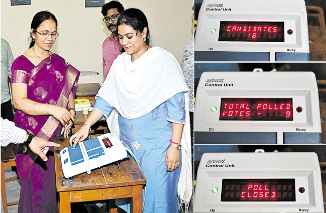 A polling officer shows how to vote during a demo at Nizam Collage in Hyderabad