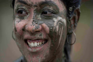 Nepalese people celebrate the festival by planting paddy, playing in the mud, singing traditional songs, eating yogurt and beaten rice.