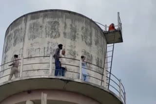 Woman climbs on water tank in Raisen