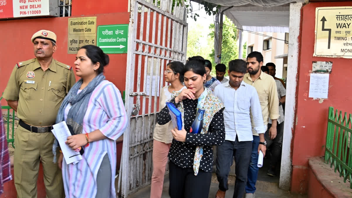 Aspirants leave examination centre after appearing in the UPSC Civil Services (Preliminary) exams in New Delhi on Sunday.