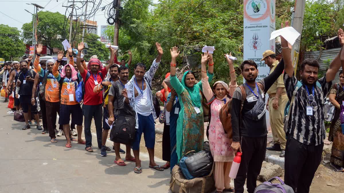Pilgrims stand in a queue to leave for the Amarnath Yatra from Jammu on Tuesday July 2, 2024