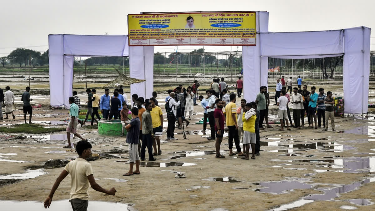 People gather at the Hathras stampede incident site which left 121 people dead during a ‘Satsang’ (congregation), at Phulrai village in Hathras on Wednesday.