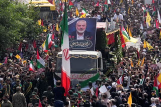 Iranians follow a truck carrying the coffins of Hamas leader Ismail Haniyeh and his bodyguard who were killed in an assassination blamed on Israel.